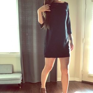 Quarter length sleeve fitted black dress